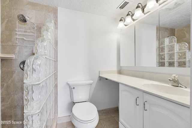 2101 S Atlantic Ave Unit 205, Cocoa Beach, FL 32931 - full bath featuring vanity, tiled shower, tile patterned flooring, and a textured ceiling