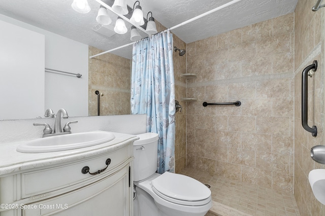 2101 S Atlantic Ave Unit 205, Cocoa Beach, FL 32931 - full bath featuring a tile shower, vanity, and a textured ceiling