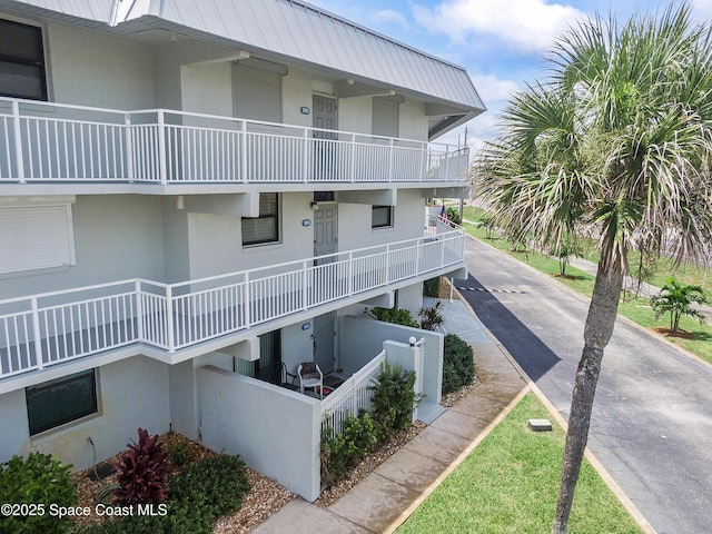 2101 S Atlantic Ave Unit 205, Cocoa Beach, FL 32931 - view of property with driveway and a fenced front yard