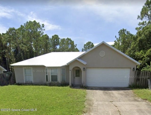507 Giovanni Rd NW, Palm Bay, FL 32907 - ranch-style house featuring concrete driveway, stucco siding, and an attached garage