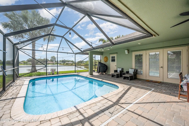 4333 Browning Ln, Rockledge, FL 32955 - outdoor pool with a patio, a water view, french doors, a ceiling fan, and glass enclosure