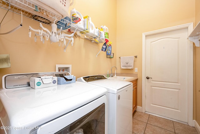 4333 Browning Ln, Rockledge, FL 32955 - washroom with cabinet space, washer and clothes dryer, and light tile patterned floors