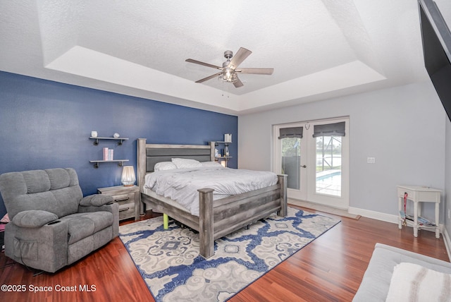 4333 Browning Ln, Rockledge, FL 32955 - bedroom featuring a raised ceiling, access to outside, wood finished floors, french doors, and a textured ceiling