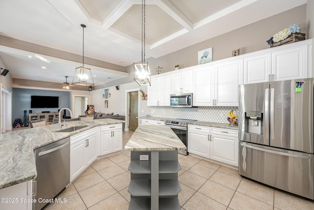 4333 Browning Ln, Rockledge, FL 32955 - kitchen with appliances with stainless steel finishes, open shelves, open floor plan, a center island, and tasteful backsplash