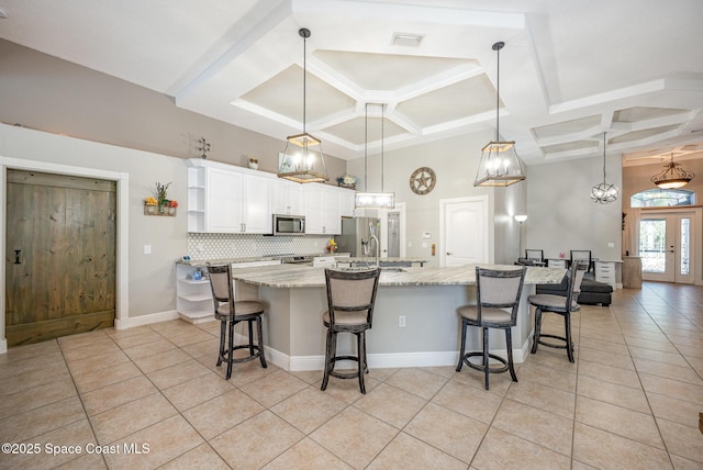 4333 Browning Ln, Rockledge, FL 32955 - kitchen with coffered ceiling, appliances with stainless steel finishes, light tile patterned floors, open shelves, and white cabinets