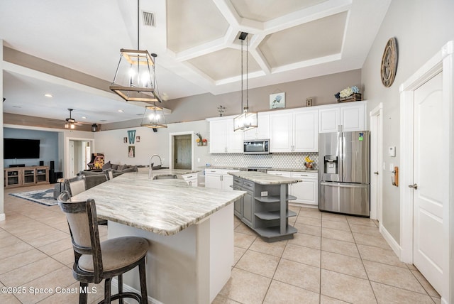 4333 Browning Ln, Rockledge, FL 32955 - kitchen featuring appliances with stainless steel finishes, a large island with sink, light tile patterned flooring, a ceiling fan, and recessed lighting