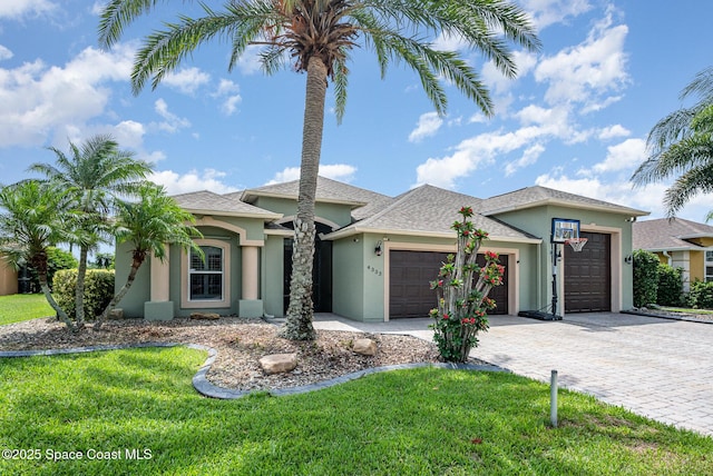 4333 Browning Ln, Rockledge, FL 32955 - view of front of home featuring stucco siding, an attached garage, decorative driveway, and a front lawn