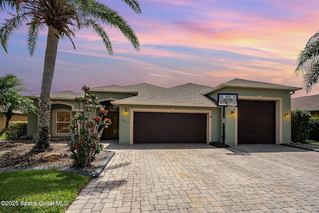 4333 Browning Ln, Rockledge, FL 32955 - prairie-style house with stucco siding, a garage, and decorative driveway