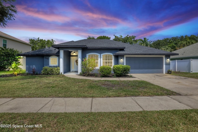 2559 Christopher Dr, Titusville, FL 32780 - ranch-style house featuring stucco siding, an attached garage, concrete driveway, and roof with shingles