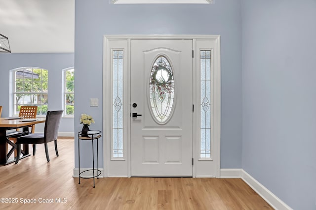 2559 Christopher Dr, Titusville, FL 32780 - entrance foyer with light wood finished floors and plenty of natural light