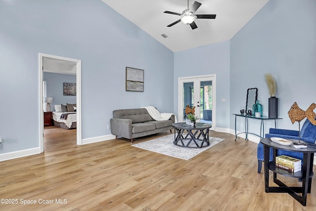 2559 Christopher Dr, Titusville, FL 32780 - living area with high vaulted ceiling, french doors, ceiling fan, and light wood-style flooring