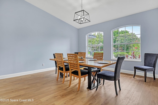 2559 Christopher Dr, Titusville, FL 32780 - dining space featuring a chandelier, light wood-type flooring, and vaulted ceiling