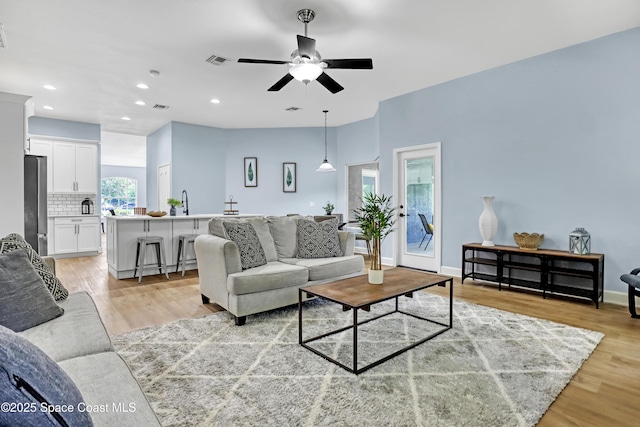 2559 Christopher Dr, Titusville, FL 32780 - living room featuring ceiling fan, light wood-style floors, and recessed lighting