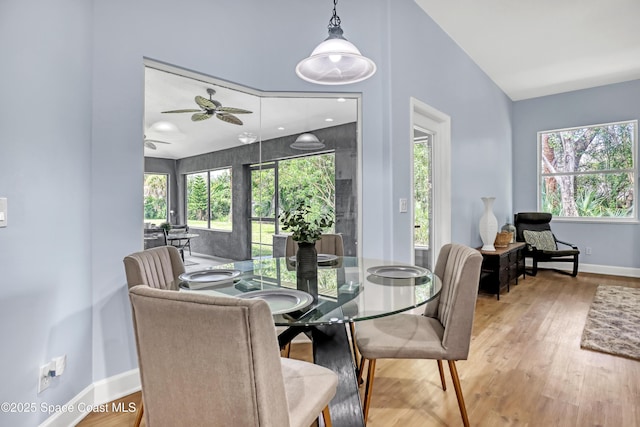 2559 Christopher Dr, Titusville, FL 32780 - dining space with a ceiling fan, wood finished floors, healthy amount of natural light, and vaulted ceiling