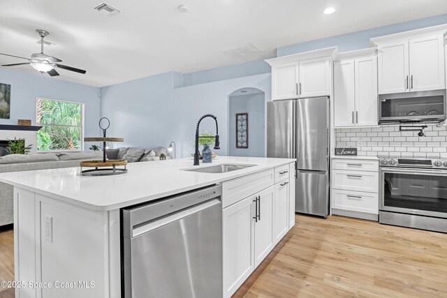 2559 Christopher Dr, Titusville, FL 32780 - kitchen with stainless steel appliances, open floor plan, white cabinetry, light countertops, and recessed lighting