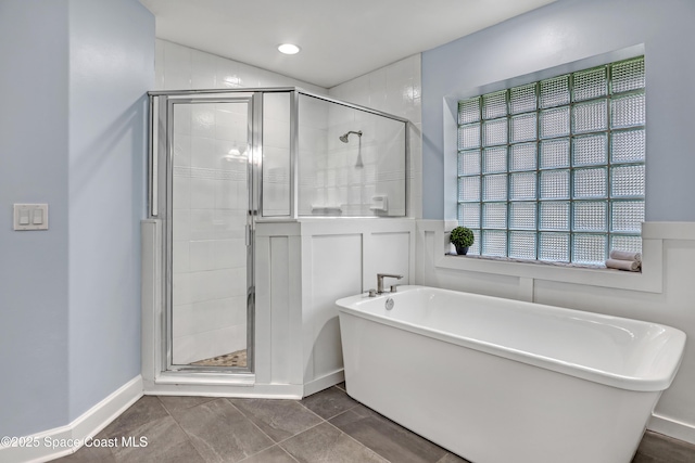 2559 Christopher Dr, Titusville, FL 32780 - full bathroom with a freestanding bath, a shower stall, a decorative wall, and wainscoting
