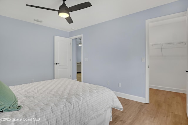 2559 Christopher Dr, Titusville, FL 32780 - bedroom featuring light wood-type flooring, a walk in closet, and ceiling fan