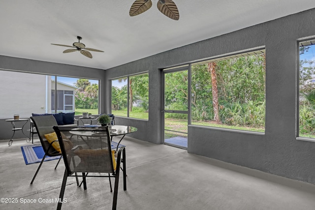 2559 Christopher Dr, Titusville, FL 32780 - sunroom featuring ceiling fan, a textured wall, concrete floors, and outdoor dining area