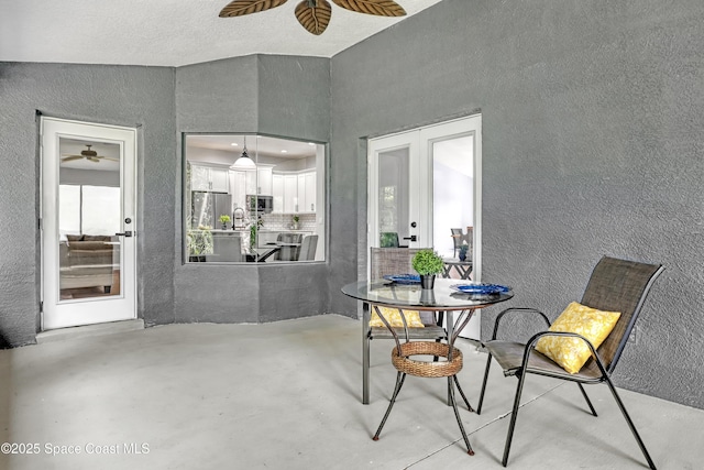 2559 Christopher Dr, Titusville, FL 32780 - dining room featuring french doors, ceiling fan, a textured wall, and concrete flooring