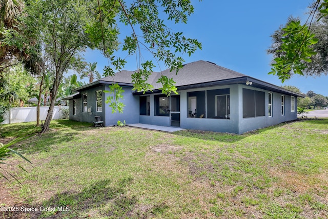 2559 Christopher Dr, Titusville, FL 32780 - back of property with stucco siding, a shingled roof, and a sunroom