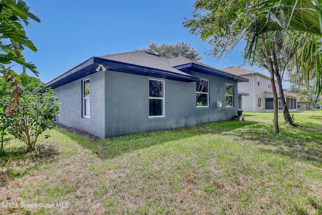 2559 Christopher Dr, Titusville, FL 32780 - view of side of home with stucco siding and a lawn