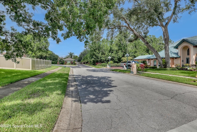 2559 Christopher Dr, Titusville, FL 32780 - view of asphalt road featuring sidewalks and curbs