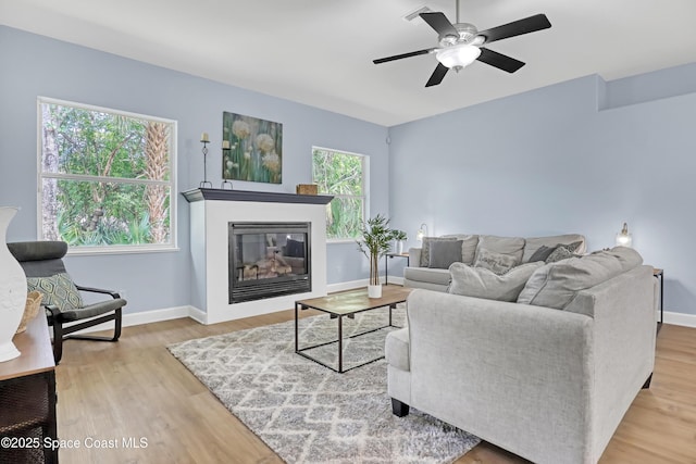 2559 Christopher Dr, Titusville, FL 32780 - living area with healthy amount of natural light, ceiling fan, and wood finished floors