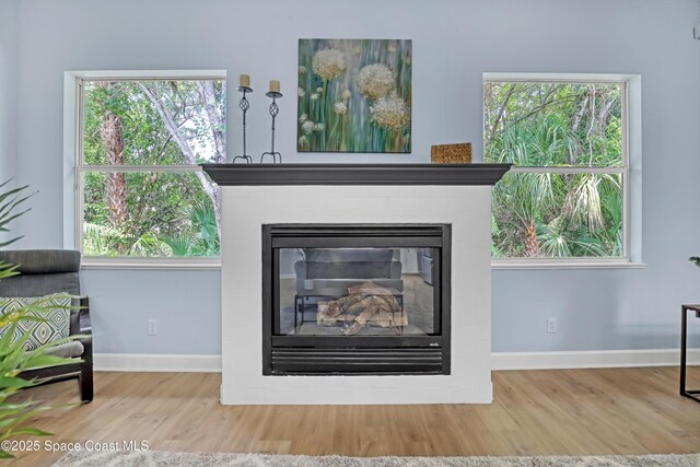 2559 Christopher Dr, Titusville, FL 32780 - detailed view of wood finished floors and a glass covered fireplace