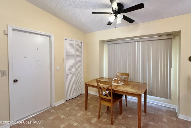 1469 California Dr, Melbourne, FL 32940 - dining area with a ceiling fan, a textured ceiling, and brick patterned floors