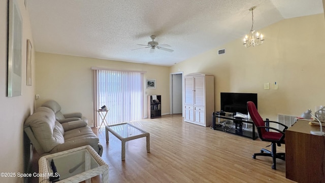 1469 California Dr, Melbourne, FL 32940 - living area featuring ceiling fan, a desk, wood finished floors, vaulted ceiling, and a textured ceiling