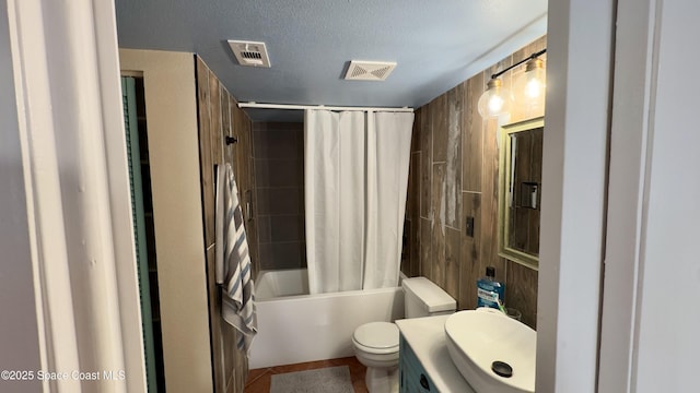 650 N Atlantic Ave Unit 406, Cocoa Beach, FL 32931 - bathroom featuring vanity, shower / bathtub combination with curtain, a textured ceiling, and tile patterned floors