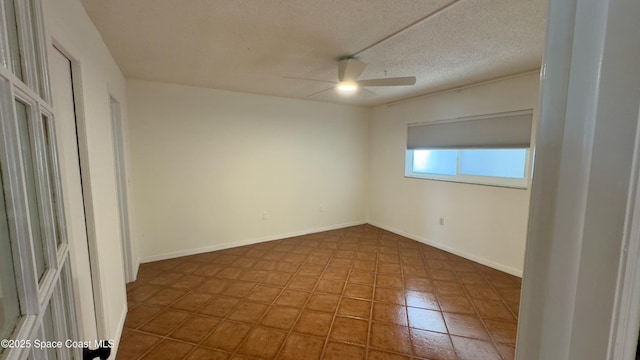 650 N Atlantic Ave Unit 406, Cocoa Beach, FL 32931 - unfurnished room with ceiling fan, tile patterned floors, and a textured ceiling