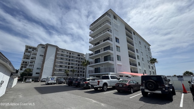650 N Atlantic Ave Unit 406, Cocoa Beach, FL 32931 - view of apartment building / complex with uncovered parking