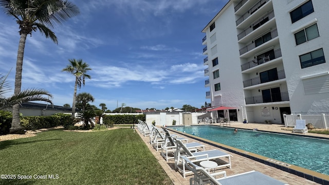 650 N Atlantic Ave Unit 406, Cocoa Beach, FL 32931 - community pool with a yard and a patio