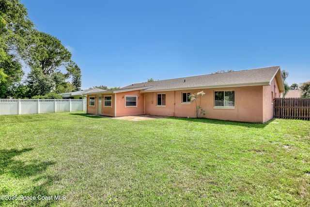 4480 Westview Ln, Titusville, FL 32780 - rear view of property featuring stucco siding, a fenced backyard, and a patio area
