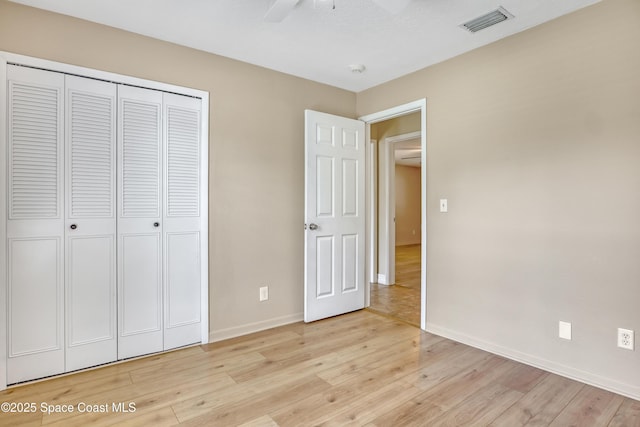 4480 Westview Ln, Titusville, FL 32780 - unfurnished bedroom with light wood finished floors, a closet, and ceiling fan