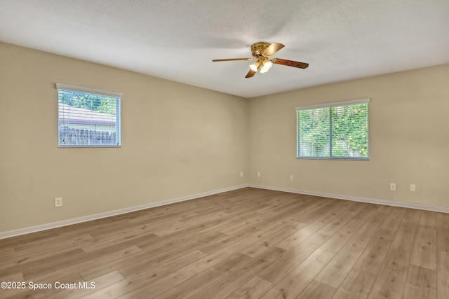 4480 Westview Ln, Titusville, FL 32780 - spare room with plenty of natural light, light wood-type flooring, and a ceiling fan