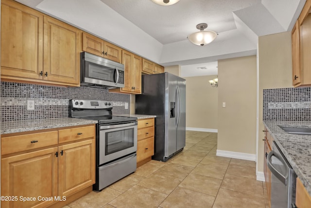 4480 Westview Ln, Titusville, FL 32780 - kitchen with appliances with stainless steel finishes, backsplash, light stone countertops, light tile patterned floors, and a chandelier