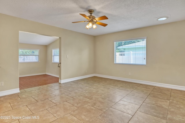 4480 Westview Ln, Titusville, FL 32780 - unfurnished room featuring healthy amount of natural light, light tile patterned floors, a textured ceiling, and ceiling fan