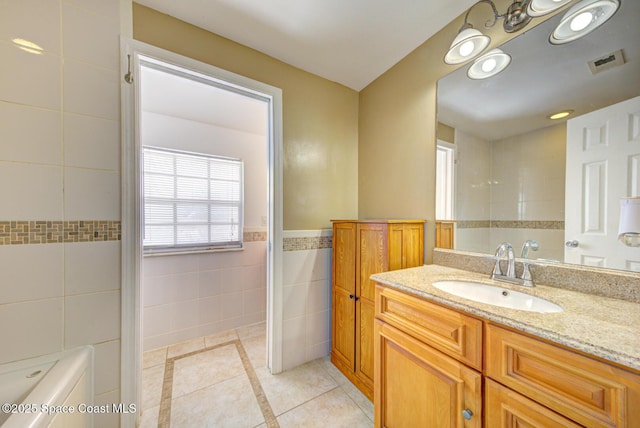949 Brunswick Ln, Rockledge, FL 32955 - bathroom with tile walls, tile patterned floors, and vanity