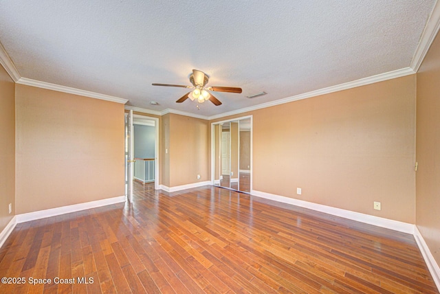 949 Brunswick Ln, Rockledge, FL 32955 - unfurnished room featuring ceiling fan, wood finished floors, a textured ceiling, and ornamental molding