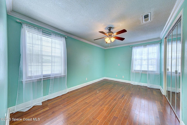 949 Brunswick Ln, Rockledge, FL 32955 - spare room featuring ceiling fan, wood-type flooring, a textured ceiling, and ornamental molding