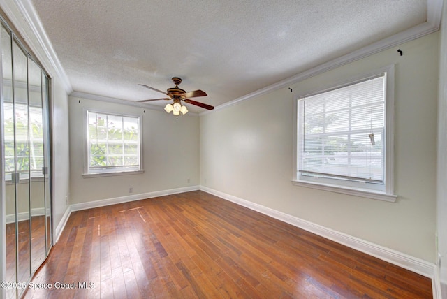 949 Brunswick Ln, Rockledge, FL 32955 - unfurnished room with ornamental molding, dark wood-style flooring, a textured ceiling, and ceiling fan