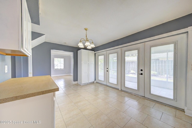 949 Brunswick Ln, Rockledge, FL 32955 - unfurnished dining area featuring french doors, light tile patterned flooring, and a chandelier