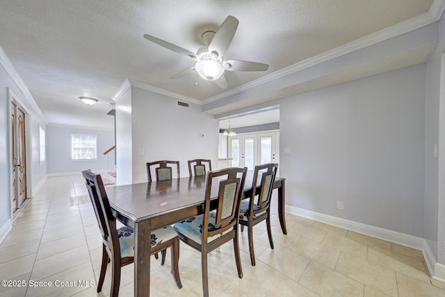 949 Brunswick Ln, Rockledge, FL 32955 - dining space with ceiling fan, ornamental molding, a textured ceiling, french doors, and light tile patterned flooring