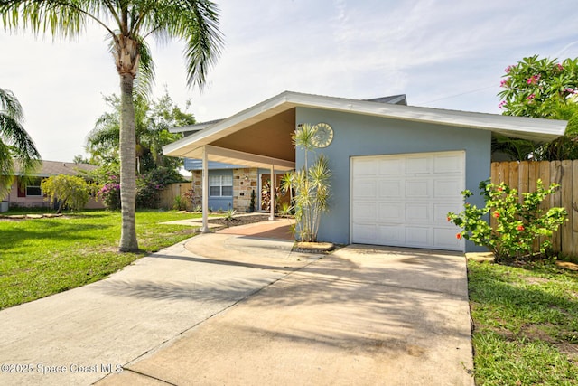 949 Brunswick Ln, Rockledge, FL 32955 - view of front of home with driveway, stucco siding, a carport, and an attached garage