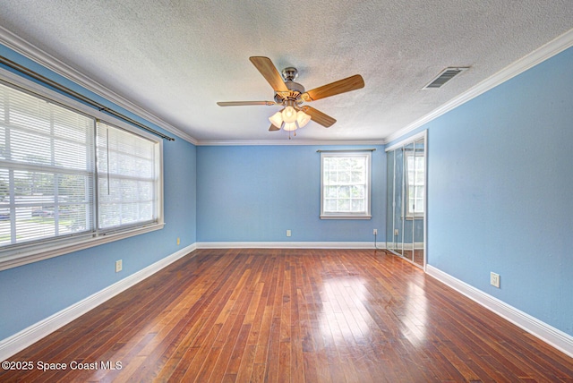 949 Brunswick Ln, Rockledge, FL 32955 - empty room featuring ceiling fan, crown molding, hardwood / wood-style floors, and a textured ceiling