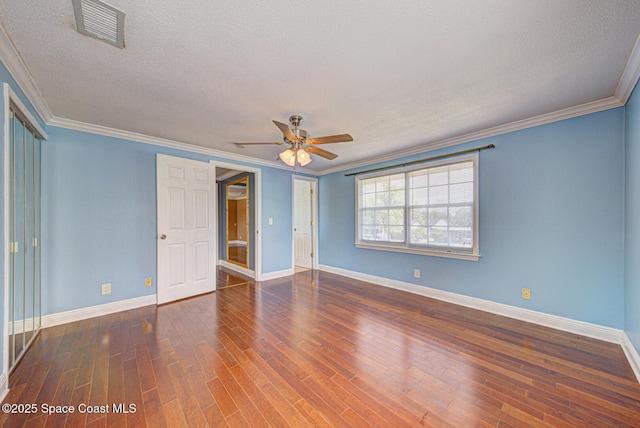 949 Brunswick Ln, Rockledge, FL 32955 - unfurnished bedroom featuring wood finished floors, a textured ceiling, crown molding, a ceiling fan, and a closet