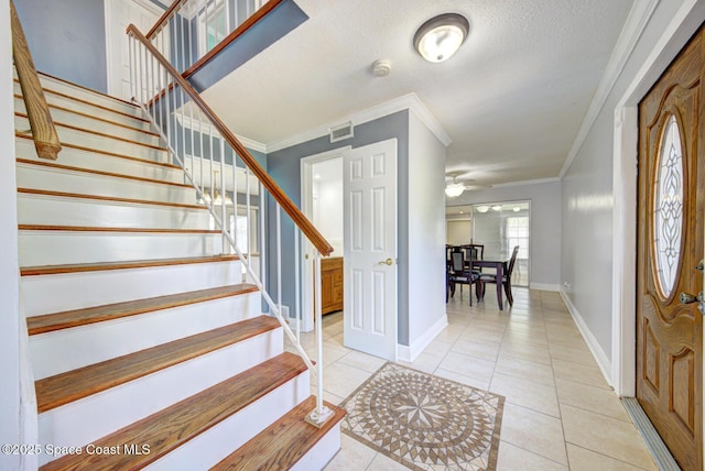 949 Brunswick Ln, Rockledge, FL 32955 - foyer entrance with stairs, crown molding, and light tile patterned floors