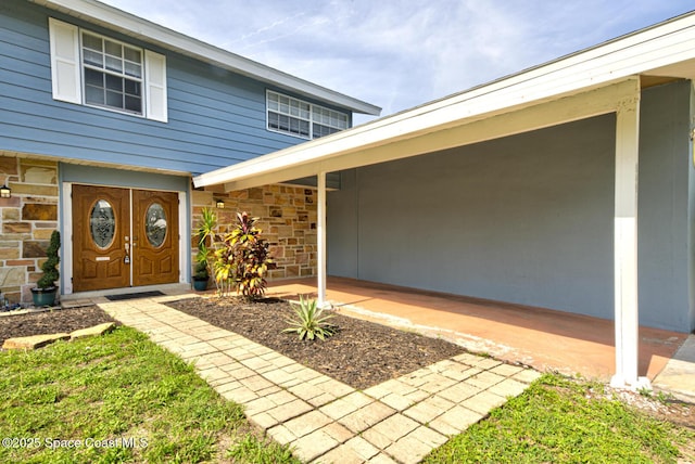 949 Brunswick Ln, Rockledge, FL 32955 - doorway to property with stone siding and a patio
